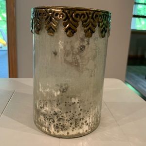 Weathered mirrored glass candle holder.